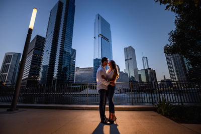 portrait of a couple in front of city skyline